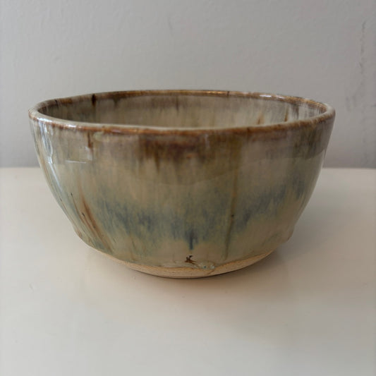Earthy blue ceramic bowl with a reactive glaze on a light background