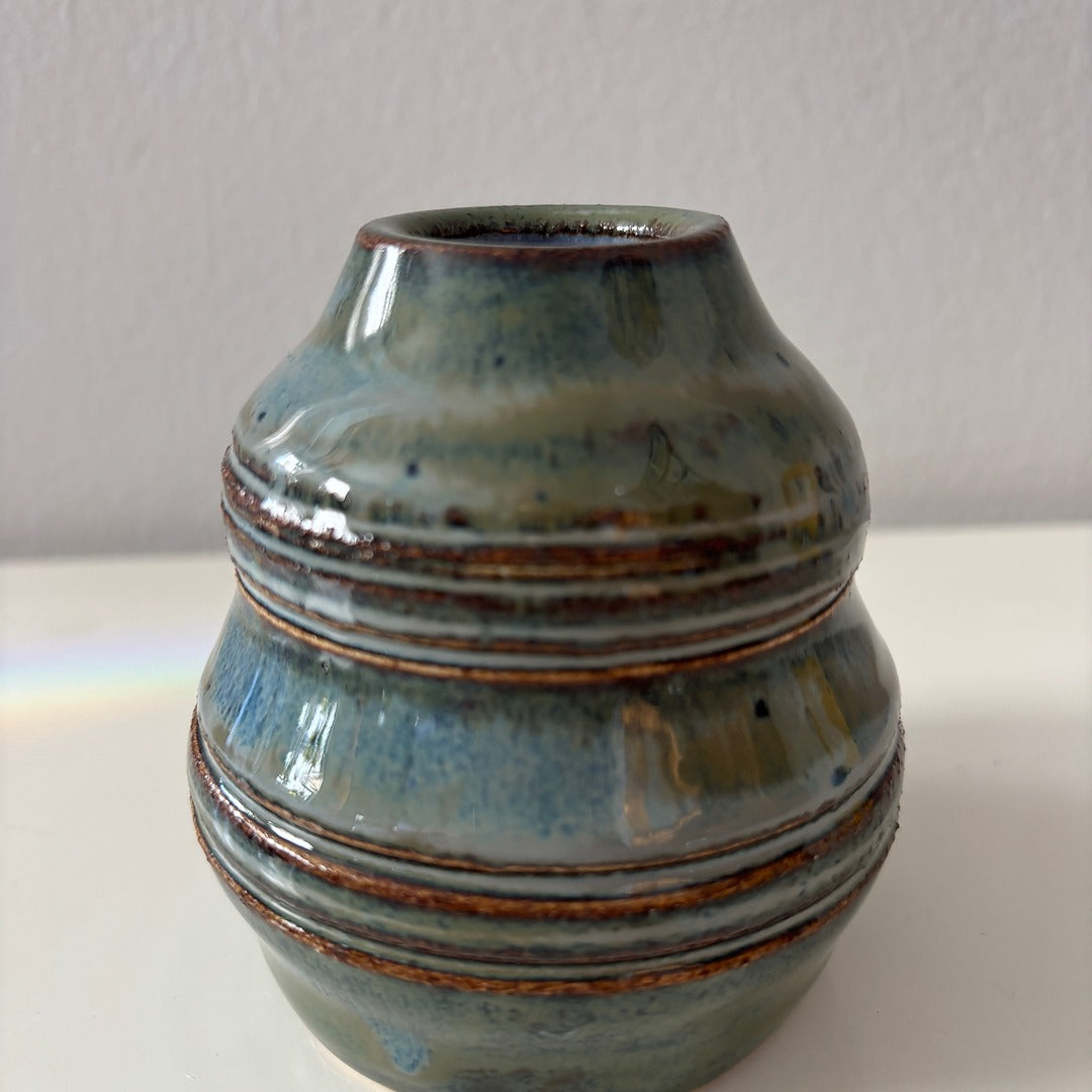 Ceramic vase with blue and brown glaze on a white background