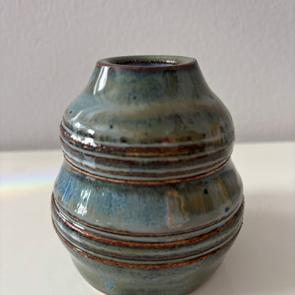 Ceramic vase with blue and brown glaze on a white background