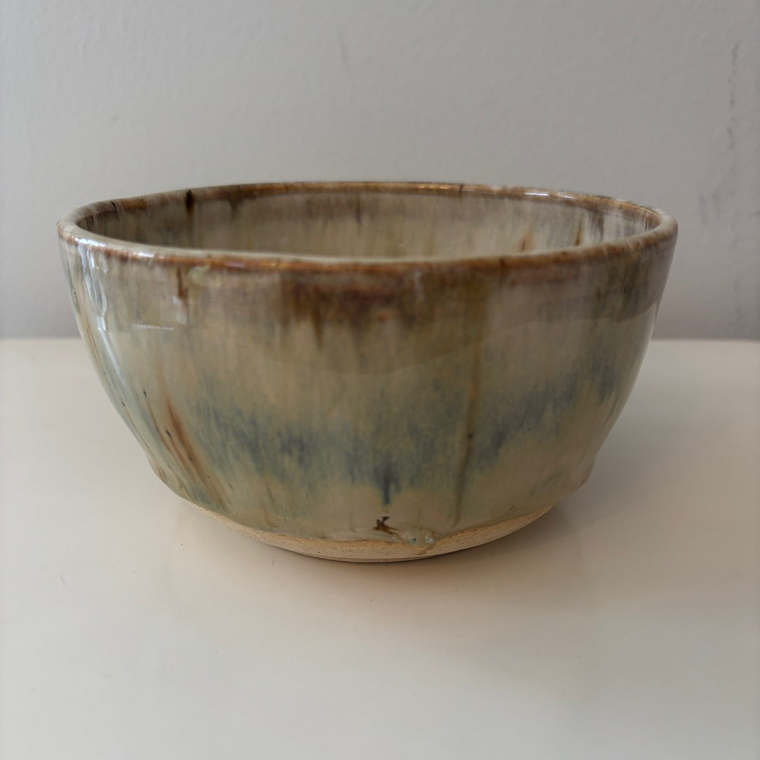 Earthy blue ceramic bowl with a reactive glaze on a light background