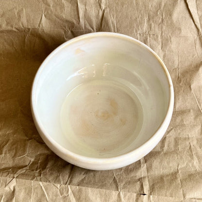 White ceramic bowl on crumpled brown paper
