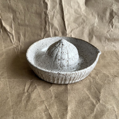 Speckled ceramic juicer on a brown paper background