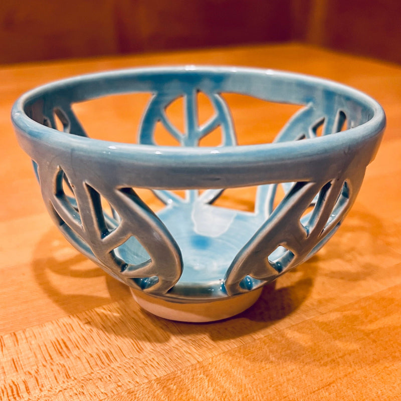 Turquoise ceramic bowl with pierced leaf carving